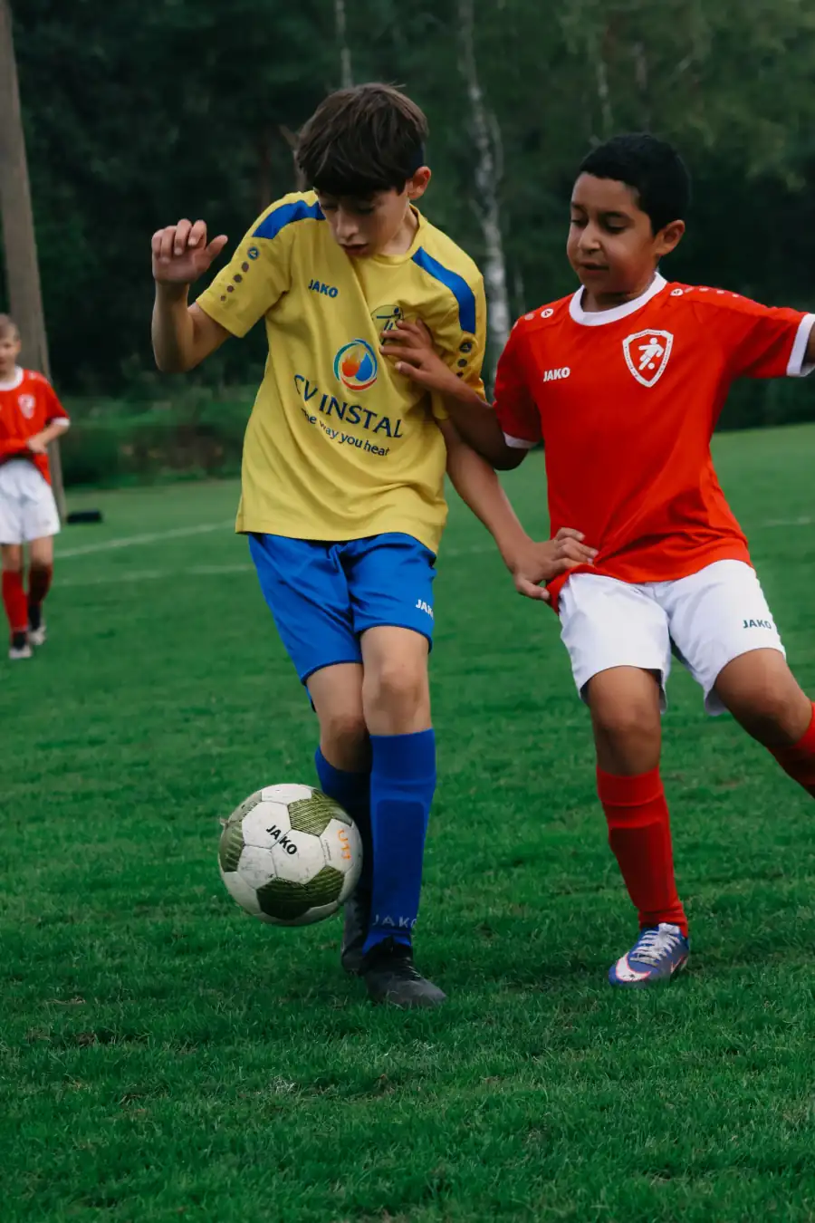 Twee spelers schouder aan schouder in duel om de bal — Ternesse, Sideline Action